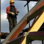 A construction worker climbs a scaffolding at the Shiliupu port in Shanghai, China.