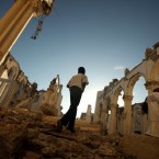 A boy walks through the destroyed Port-au-Prince cathedral before the anniversary services began. Less than a tenth of the rubble has been cleared in the capital city.
