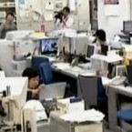 Office workers brace themselves during the second earthquake (this one a 7.1 magnitude) to hit north east japan in less than a month.