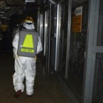 Workers wearing protective suits enter a part of the Fukushima Daiichi plant: Tokyo Electric said Tuesday that additional meltdowns likely occurred at Reactors 2 and 3.