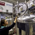A PhD student transfers liquid helium into the superconducting magnetic trap that was used to capture antimatter for nearly 17 minutes at a time.