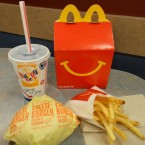 McDonald's caves to public pressure with a healthy update of its classic kids' Happy Meal including half as many french fries and obligatory apples.