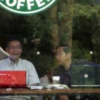 People work on their laptops at a Starbucks: Some New York locations may block electrical outlets so customers don't hog tables all day.