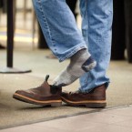 A passenger removes his shoes at the Sacramento international airport: Homeland Security Secretary Janet Napolitano says travelers might soon be able to keep their kicks on during security screenings.
