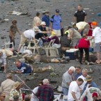 People rush to help injured spectators following the deadly crash Friday of a vintage World War II-era fighter jet at the annual Reno, Nev., air race.