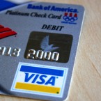 Bank of America will initiate $5 monthly debit card fees starting early next year, and customers are threatening to walk out on the banking giant.