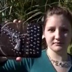 Vanessa Gibbs displays a favorite purse embellished with a western-style gun design: Overzealous TSA officials flagged the purse as a security risk.