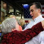 A newly accessible Mitt Romney hugs a supporter during a town hall meeting in Iowa.