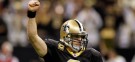 New Orleans Saints quarterback Drew Brees celebrates after throwing a nine-yard touchdown pass and breaking the single-season passing record formerly held by Dan Marino.