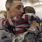 A soldier hugs his child during a homecoming ceremony at Fort Bliss, Texas: Because of familial strains or trauma of war, soldiers say it is harder coming home than leave.