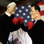 A woman holds boxing hand puppets of Newt Gingrich and Mitt Romney: The two GOP presidential frontrunners have been tearing into each other ahead of Thursday's debate in Florida.