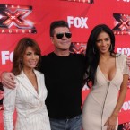 Simon Cowell fired fellow judges Paula Abdul and Nicole Scherzinger Monday night in a shake up that is dividing critics.