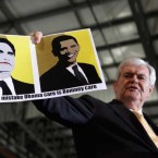 Newt Gingrich holds up a supporter-made sign: Negative campaign ads may have helped Mitt Romney win Florida and critics say the attacks will only mount as the general election nears.