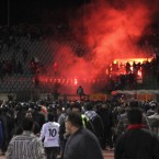 Soccer fans flee from a fire at Port Said Stadium in Cairo Thursday: 74 people were killed in a breach of security that critics say may allow the military to prolong its hold on Egypt.