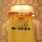 A Tea Party shirt hangs from a lamp at a Newt Gingrich rally: Because the movement failed to unite behind one candidate, its influence is dimming in the presidential race, say some Tea Partiers.