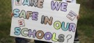 Students of Miramonte Elementary School in Los Angeles hold signs during a march: Two teachers at the school have been charged with sexual abuse and the entire staff replaced.