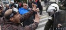 Anti-austerity protesters confront riot police Friday: Greek leaders have agreed to a new round of unpopular job and spending cuts.