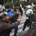 Anti-austerity protesters confront riot police Friday: Greek leaders have agreed to a new round of unpopular job and spending cuts.