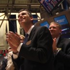 Traders applaud in February as the Dow Jones Industrial Average breaks the 13,000 barrier for the first time since May 2008.