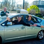 Google executives Eric Schmidt, Larry Page, and Sergey Brin pose in their self-driving test model car.