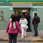 People file into a government job center in Chipiona: Spain has the largest unemployment rate in the eurozone, which is only hurting the country's crippling debt problem.