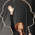 The Argentine president holds an Eva Peron sculpture: Kirchner's nationalization moves have won populist support, reminding many of the famed populist leader.