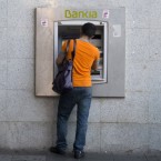 A man withdraws cash from a Bankia ATM in Madrid: Spain's third-largest bank has requested a $24 billion bailout.