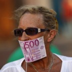 A woman protests Spain's bank bailout, which may only be a Band-Aid for the continent's fourth-largest economy.