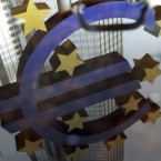 The euro symbol is reflected in a puddle in front of the European Central Bank in Frankfurt, Germany: Eurozone leaders meet in Brussels Thursday to decide the monetary system's fate.