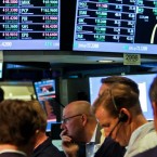Traders work below the Dow Jones Industrial Average ticker at the New York Stock Exchange July 13: Experts say it's time for Apple to join the venerable index.