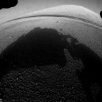 Not wanting to waste any time, NASA's overachieving Curiosity rover beams back images of Mars' surface, with its shadow center, using a "fisheye" wide angle lens.