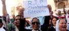 A demonstrator holds a sign during a rally in Benghazi condemning the killers of the U.S. Ambassador to Libya, Chris Stevens, and the attack on the U.S. Consulate.
