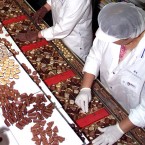 Employees in a Swiss chocolate factory: On average, every man, woman, and child in Switzerland eats 120 bars of chocolate each year.
