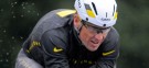 Lance Armstrong competes in a triathlon wearing Nike gear on Oct. 7: The sportswear giant has dropped the troubled athlete. "Nike does not condone the use of illegal performance-enhancing drugs in any manner," the company said in dumping Armstrong.