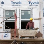 Workers apply brick facing to a group of new row houses in Chicago on Oct. 17.