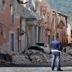 A policeman stands in front of collapsed buildings after an earthquake in Aquila, Italy, on April 7, 2009.