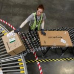 An Amazon employee sorts packages in Arizona: The online retailing giant's deep discounts may be problematic to its bottom line.