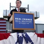 Mitt Romney at an Iowa lectern outfitted with his new motto on Oct. 26.