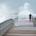 A woman walks along a jetty in Ponce Inlet, Fla., on Oct. 26: Hurricane Sandy and the oncoming Frankenstorm may be the election's real October surprise.