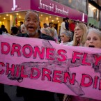 American citizens hold a banner that reads "Drones fly children die" during an anti-war rally in Pakistan on Oct. 5, 2012.