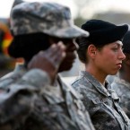 U.S. Army soldiers salute during a 2009 memorial service: Women are barred from taking some 238,000 military positions.