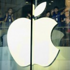 Apple staff members cheer before the Oct. 20 opening of the new Apple store in Wangfujing shopping district in Beijing.