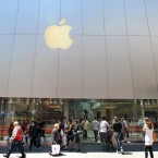 Pedestrians walk past an Apple Store in San Francisco.