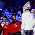 First Lady Michelle Obama reads a story to children at the National Christmas Tree Lighting Ceremony in 2009.