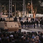 Egyptian riot police stand guard as protesters demonstrate in front of the presidential palace in Cairo on Dec. 7.