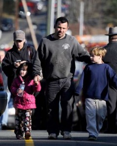 Parents leave a staging area after being reunited with their children following the shooting in Newtown, Conn.