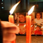 A boy pays his respects to the victims of the Sandy Hook Elementary shootings during a candlelight vigil in Tirana, Albania.