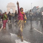 An Indian protester chants as she braces herself against water fired from police cannons during a demonstration against the gang-rape of a young woman.