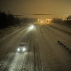Motorists travel slowly on a snow-covered Interstate 24 during a winter storm Dec. 26, in Paducah, Ky.