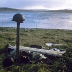 Steel helmets mark a makeshift grave for Argentines killed in the Falklands War.
